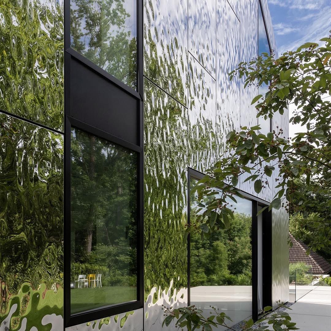 House 10 x 10 by Titus Bernhard Architekten, completed in 2023 in Neusäß, Germany, exemplifies sustainable, compact design.

Continuing the firm’s "habitable sculptures" series, the house features a timber frame enveloped in ultra-thin, 3D-formed stainless-steel panels, giving it