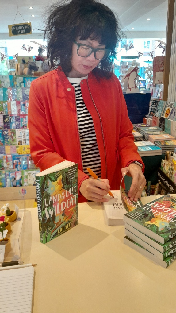 WimbledonBooks's tweet image. Huge thanks to lovely Lui Sit who popped in to sign copies of her debut novel 'Land of the Last Wildcat'. Chosen as Waterstones book of the month. A magical adventure with a warm heart. So sorry I took the picture when you had your eyes shut - whoops 🤣 @panmacmillan