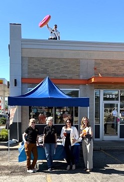 ECCI President/CEO Jennifer Veremis supports the Elmhurst Police Department's participation in the Elmhurst Dunkin Donuts' Cop on a Rooftop campaign benefiting Special Olympics Illinois.