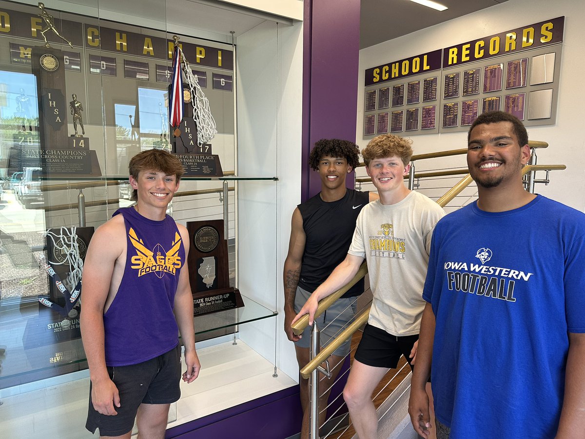 SagesAthletics's tweet image. On their final day of high school, the four @SagesFootball captains put the IHSA Class 3A state trophy in the Sievers Center Trophy Case! #Tradition #GoSages