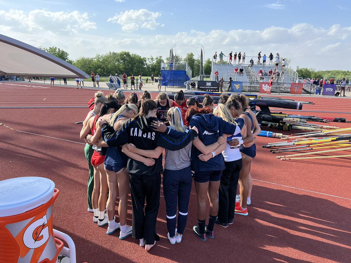 Big 12 pole vault finalists gather for a group prayer before competition begins