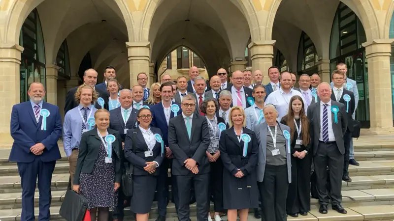 reformexposed's tweet photo. West Northamptonshire Council had their first Council meeting. The photo here shows the new council group. What is noticeable is that 6 councillors are not in it.

Guess who is also missing? Nicholas Humphries, who we previously highlighted didn’t canvas, and didn’t show up to the count:
https://t.co/NO83kUfyM5

Will we see more Reform UK council quitters in the next couple of weeks?

What’s also strange is that Group Leader Mark Arnull didn’t turn up to the first meeting.