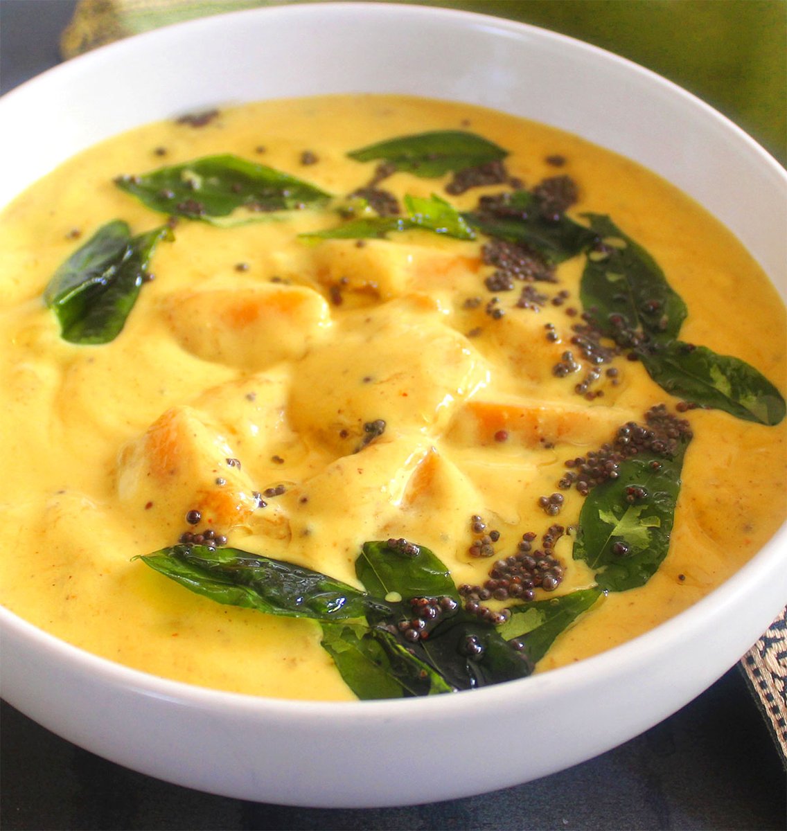 This summery Indian mango curry is spicy, sweet and salty, with a smooth creaminess that coats your tongue. Make it in one pot in under 20 minutes. #vegan #Mango 
holycowvegan.net/mango-curry/