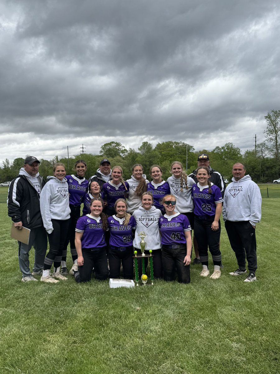 Gladstone Braves softball poses with their champipnship trophy after winning three games today to take the tournament title in Saginaw.