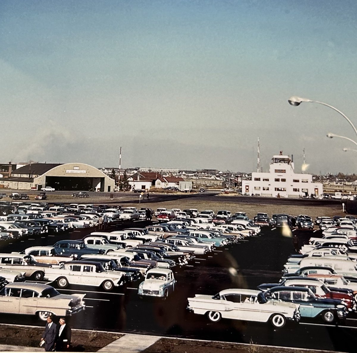 WayneMantykaCTV's tweet image. The photo was taken from the newly completed Regina airport terminal in about 1960. The previous terminal was still standing across the freshly paved parking lot. The aircraft hangar to the left still exists today. The photo is from the John Kirkland collection.