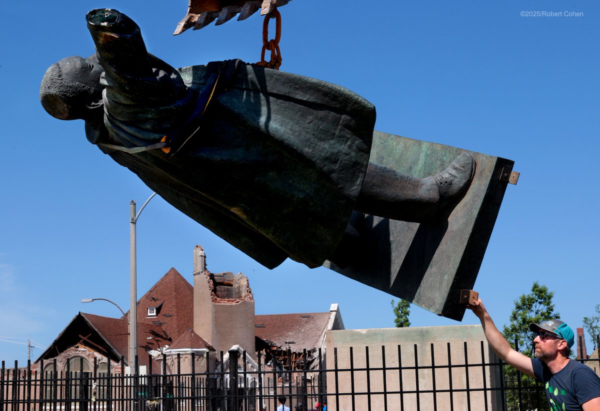 Tony Rocca recovers the tornado-damaged statue of Dr. Martin Luther King, Jr. from Fountain Park in St. Louis, where Friday's tornado killed a woman inside the nearby Centennial Christian Church. King's hand, torn away in the storm, was taken by a neighbor for safekeeping.