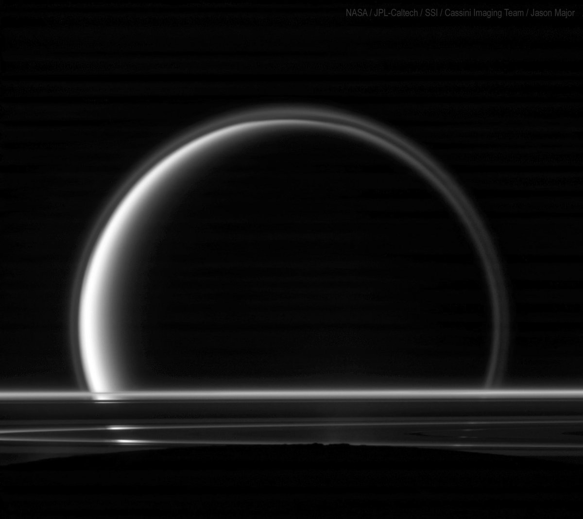 JPMajor's tweet photo. Titan and Saturn's rings seen beyond the night limb of Enceladus (the dark area across the bottom) by Cassini on May 18, 2010 https://t.co/KkPiH6BCIB