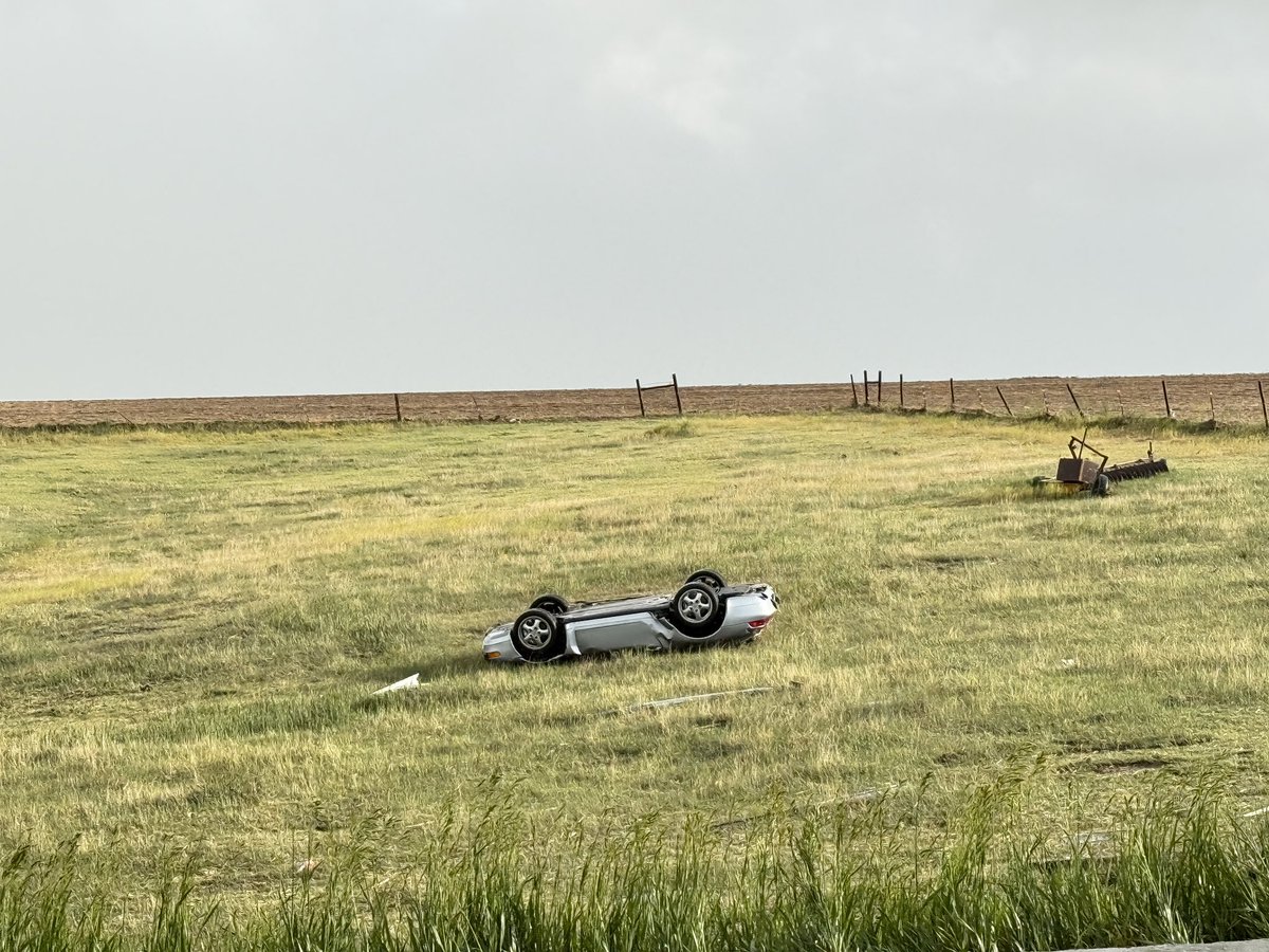 StormCoker's tweet photo. Flipped Porsche on I-70 near Grinnell, KS. Occupants made it out. Tornado weakened on it’s way into town @NWSGoodland https://t.co/zJC1tE5liO