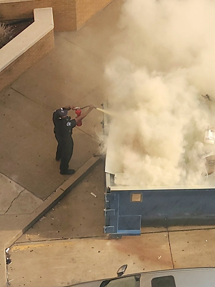 UMMCPolice's tweet photo. UMMC Police pulling double duty and extinguishing a dumpster fire next to the Critical Care Tower on Sunday. The Jackson Fire Department is investigating the cause of the fire. #UMMCPD #AnythingButRoutine https://t.co/sNFUnfPHam