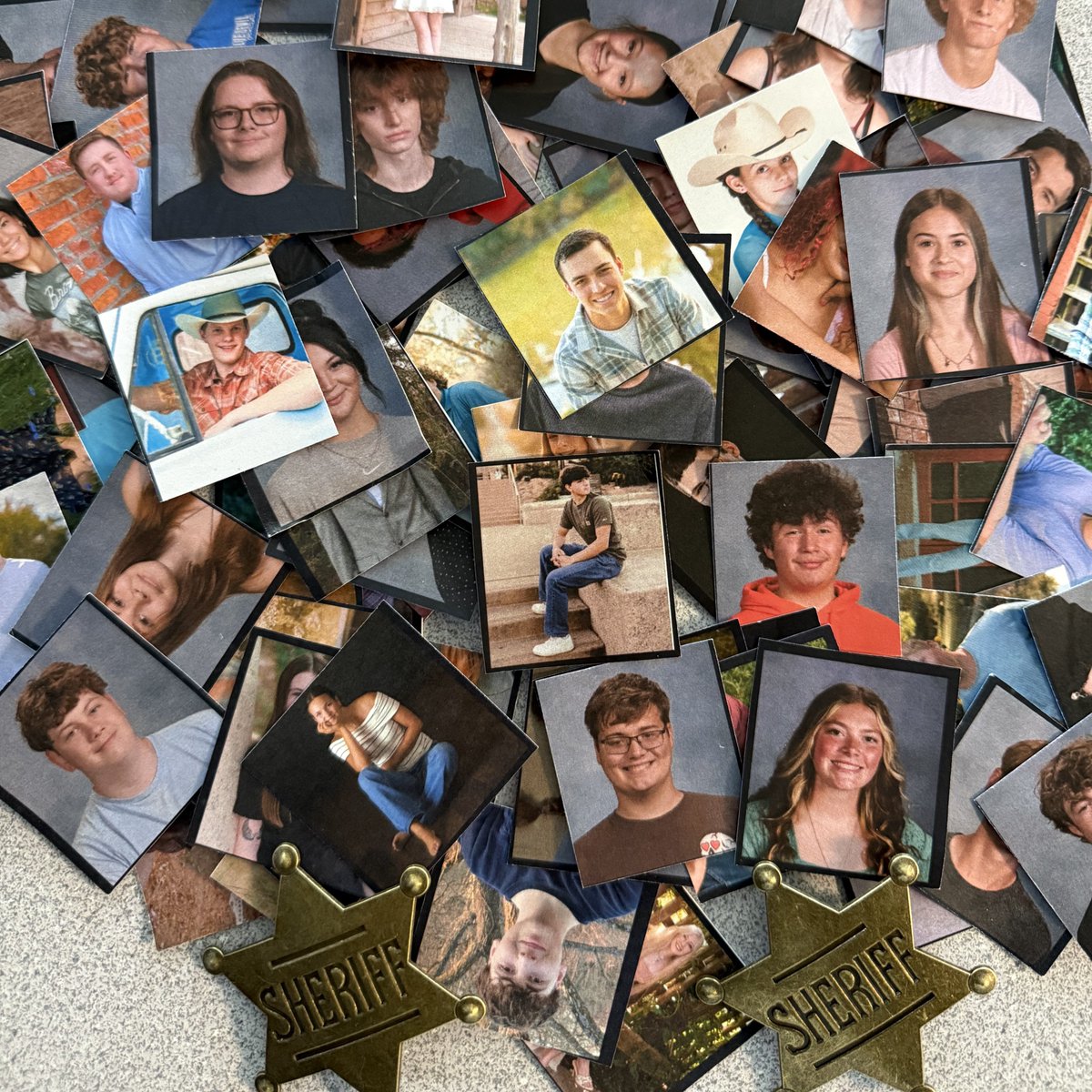 SuperHalv's tweet photo. As each graduate walked across the stage, they handed me a keepsake photo. I  also received two "Sheriff" badges since that is a nickname some students have given me. 
#Plattsmouth2025Grads https://t.co/3G3g2goKVO