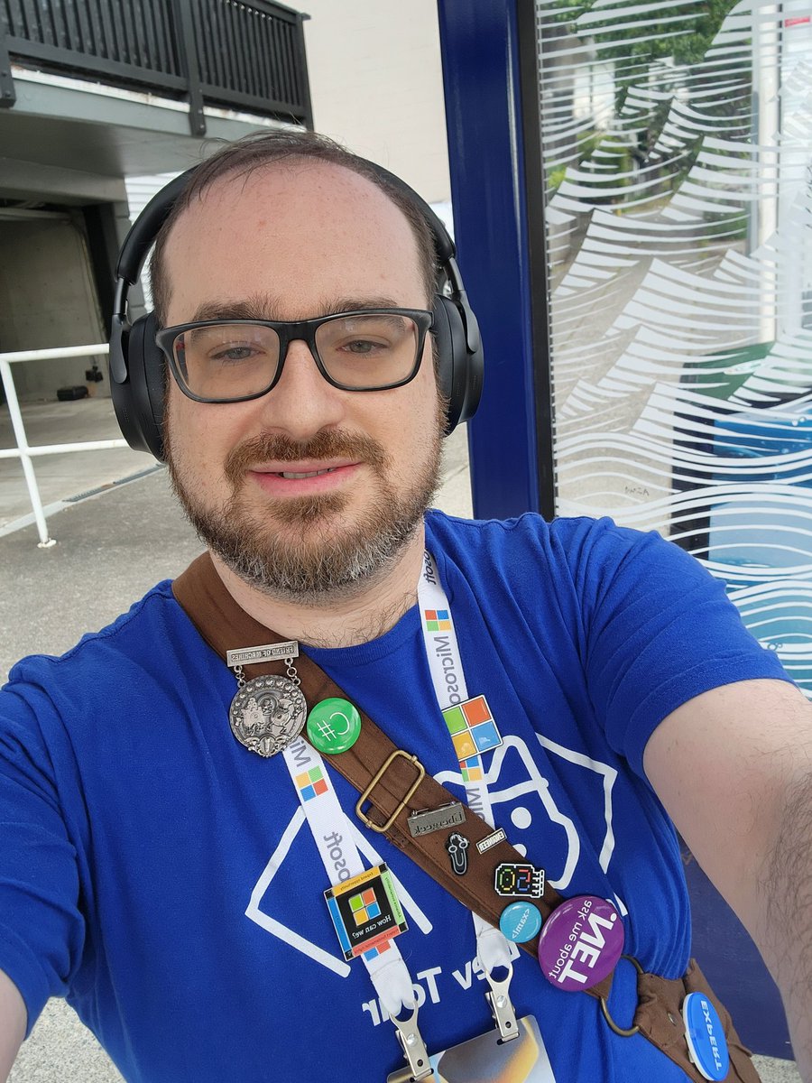 Shmuelie's tweet photo. Day two of #MSBuild! I'm a bit late today but no rain! Still in the kilt and with extra bling today! Ready to help you with #dotnet #csharp #wpf #winui #microsoftstore #winforms https://t.co/a77rtNuZbJ