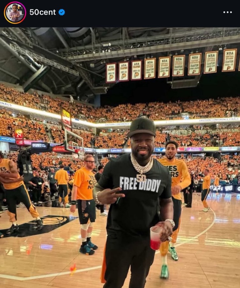 Deadspin's tweet photo. 50 Cent wearing a Free Diddy shirt courtside at Game 4 https://t.co/fHnvLkETRJ