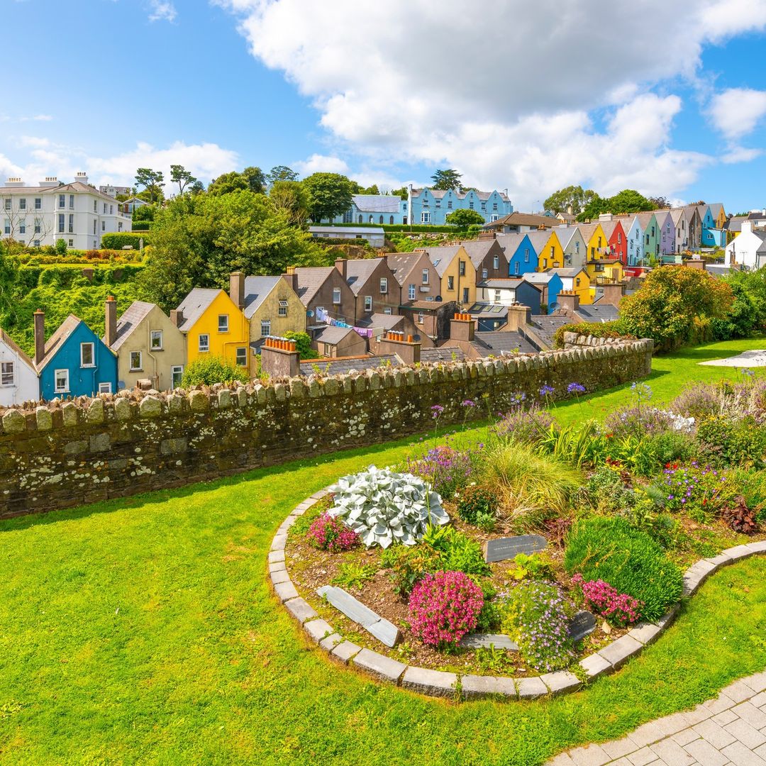 Step into a scene straight out of a postcard in the charming coastal town of Cobh, Ireland! 🏡✨ The iconic Deck of Cards, with its vibrant hues, paints a picture of quaint beauty against the backdrop of Cork County's coastline.