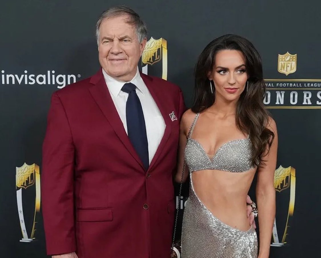Bill Belichick and his 24-year-old  girlfriend are engaged to be married. 
What do you think she sees in him?