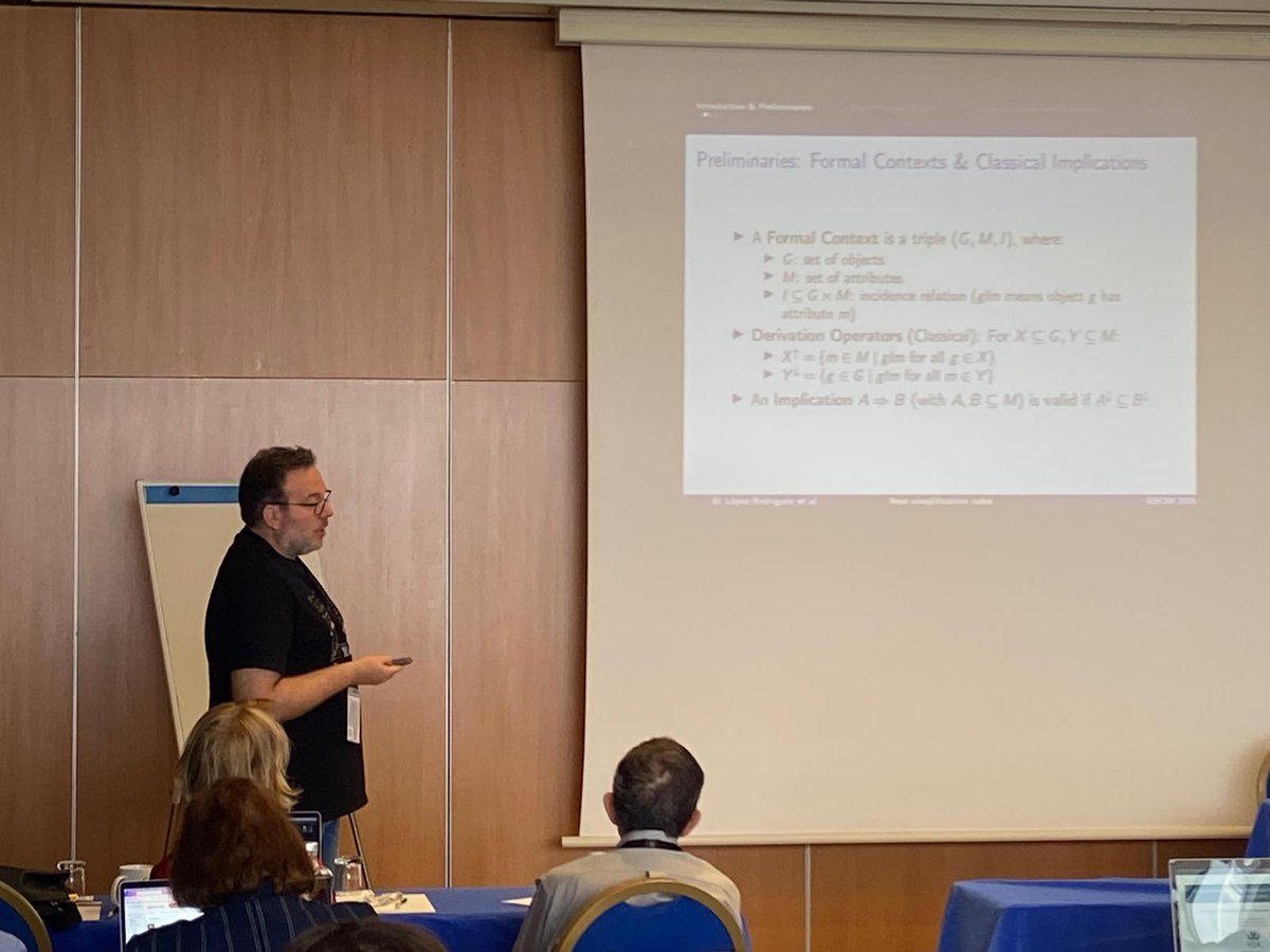 ESCIMconference's tweet photo. In the special session "Recent Trends in Knowledge Representation and Modelling" at #ESCIM2025: Domingo López-Rodríguez from @InfoUMA presents “(Ab) New Simplification Rules for Databases with Positive and Negative Attributes”. #Databases #KnowledgeRepresentation #Logic https://t.co/IHLpxr9rf6