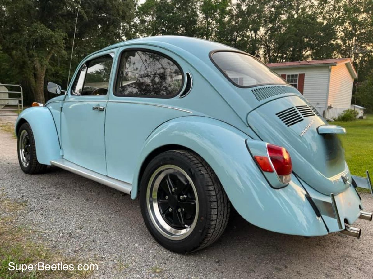 The rear engine is due to the original design philosophy emphasizing simplicity, affordability, and practicality. This rear-engine, rear-wheel-drive layout simplified the drivetrain, reducing costs and weight while providing excellent traction, especially in adverse conditions