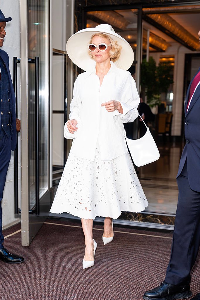 Pamela Anderson wears the Addy Top in Off White, Olene Skirt in White Broderie Anglaise and Slope Shoulder Bag in Optic White

#proenzaschouler #pamelaanderson