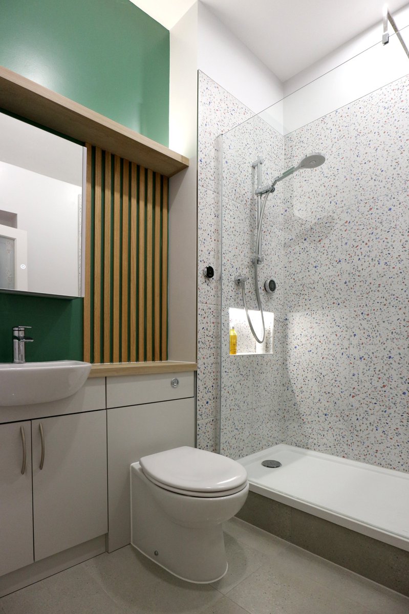 Such a Gorgeous Bathroom Renovation showcasing large format tutti frutti terrazzo tiles, an impressive  walk-in shower, a vivid green accent wall and oak panelling all add to the luxurious feel. Explore more here - s-des.co.uk/sawbridgeworth… #bathroomvibes #showers