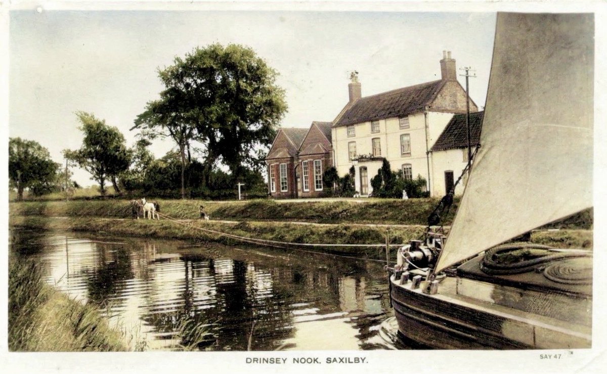 I’ve colourised one of my favourite views from the Group’s ‘John Wilson Collection’.
Dating from around 1910, the view shows ‘The Old Buffalo’, a former pub, but by this time a teetotal tearoom.
With tennis courts, a croquet lawn, and boat hire, many flocked from Lincoln.