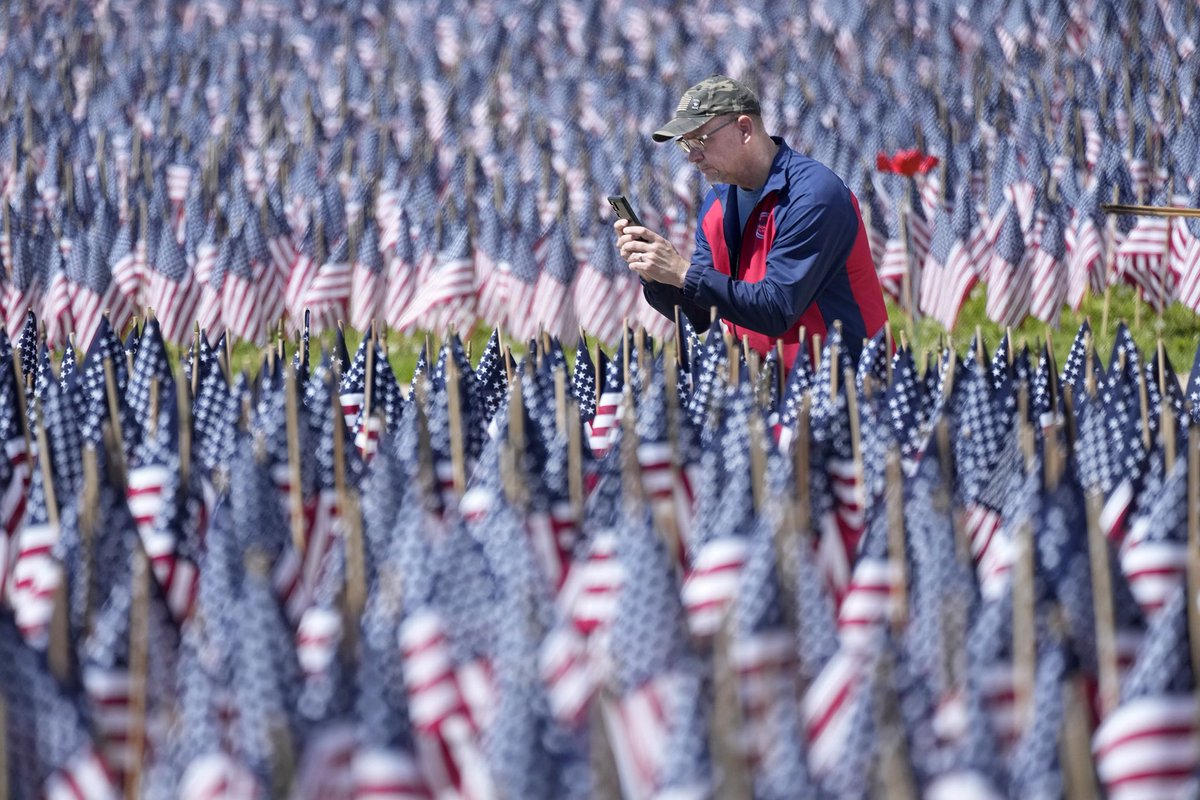 Jim Hauke, a 20-yr Army Reserve Vet from Oak Creek, takes a photo of the Field of Flags set up outside the War Memorial Center in Milwaukee. Each of the 8,390 flags set up over the Memorial Day weekend represent Wisconsin soldiers who lost their lives during World War II.
