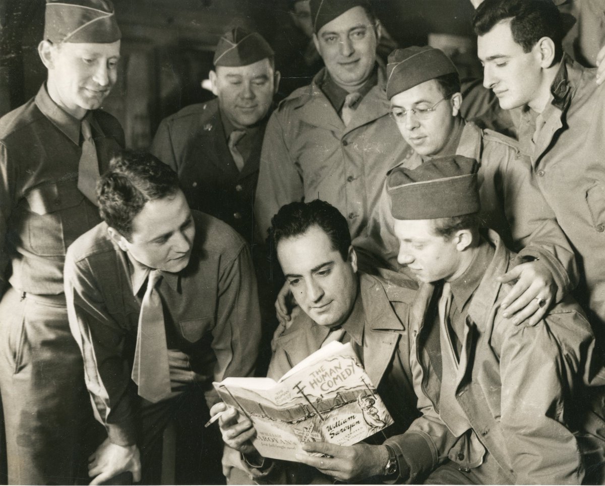 1943 - William Saroyan reading his copy of The Human Comedy to fellow troops.
