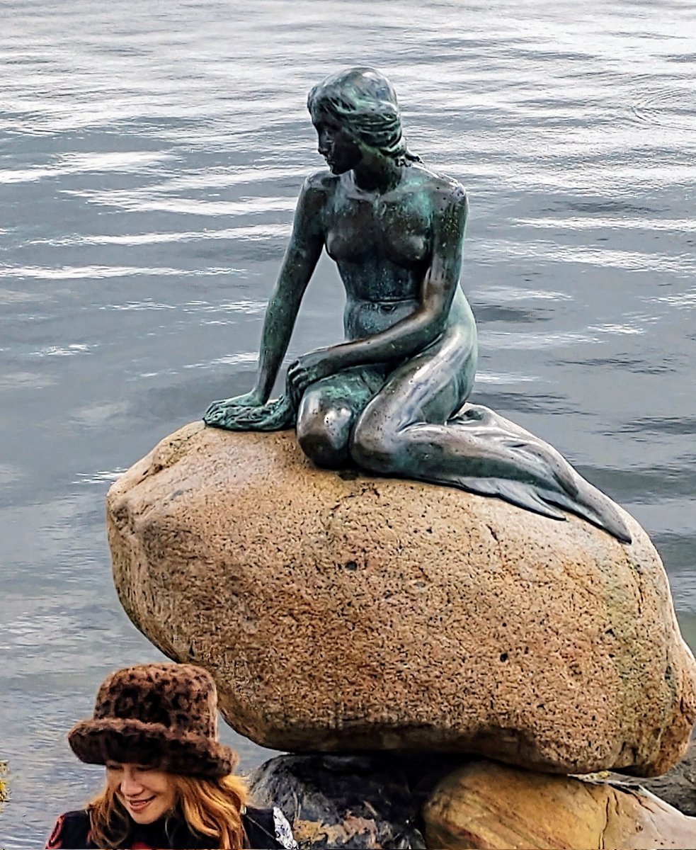 You can't really go to Copenhagen without getting a shot of the iconic Little Mermaid. Of course, I did! But what a pleasant surprise to find, when reviewing my photos, that I also captured a lovely bonus lady with a truly impressive hat.😀