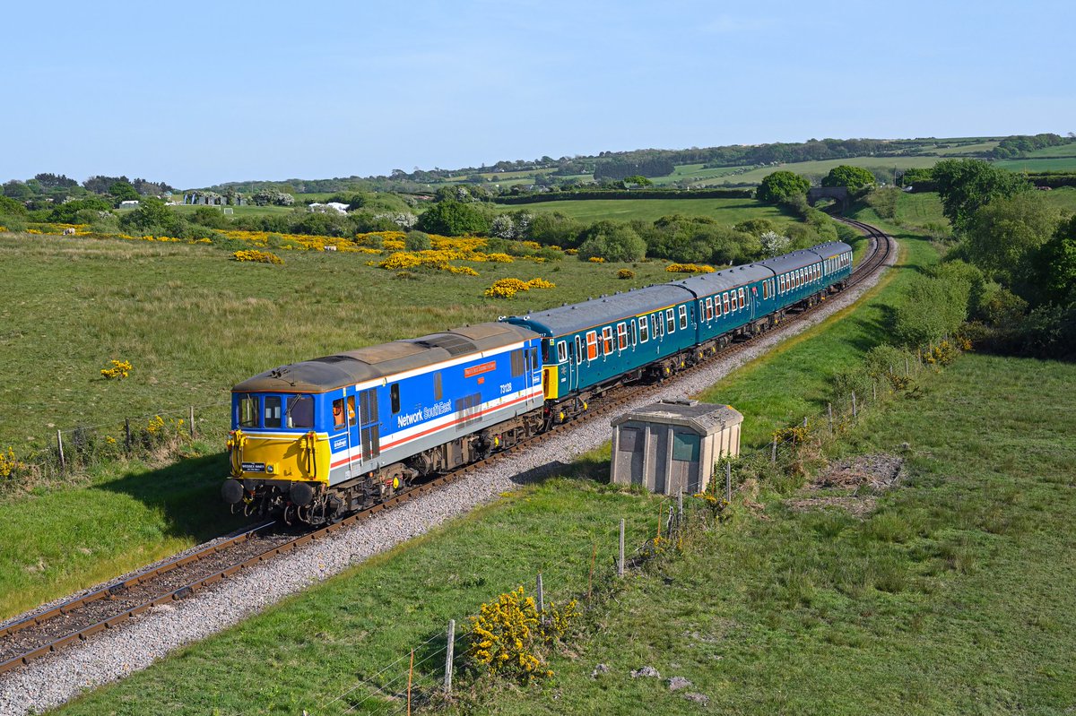 Mimicking southern scenes of old, 73128 'Kent &amp; East Sussex Railway / 50 Years of Heritage 1974 - 2024' hauls Class 423 '4-VEP' EMU no 3417 'Gordon Pettitt' through a gorse-covered Corfe Common on 10/5/25 with the 1N34 Swanage to Norden service.

#SwanageRailway #DieselGala #NSE