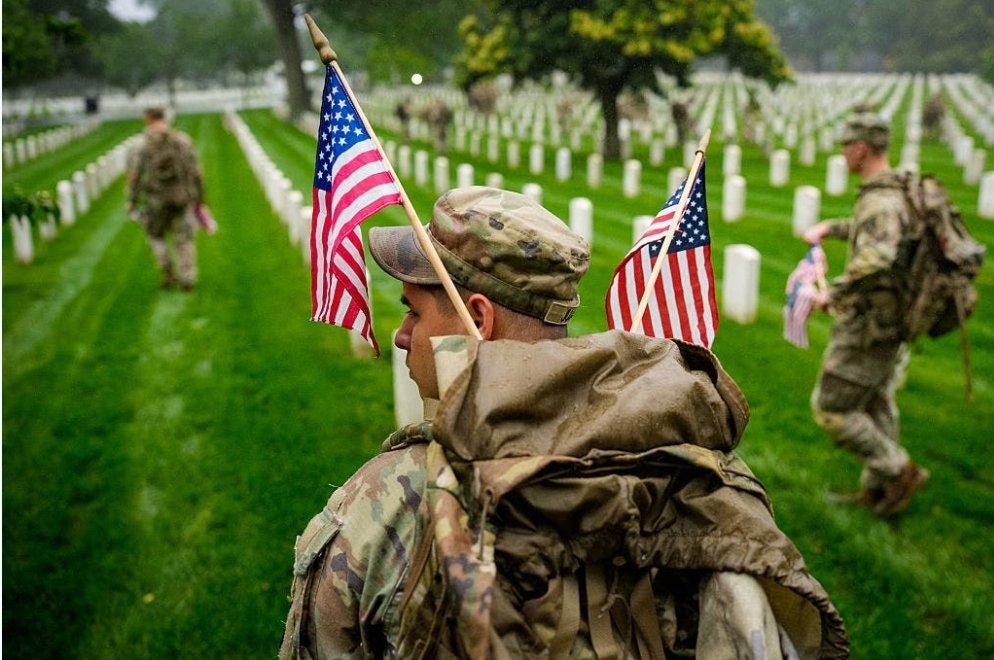 Members of the 3rd U.S. Infantry Regiment place flags at the headstones of U.S. military personnel buried at Arlington National Cemetery in preparation for Memorial Day. (Photo: Andrew Harnik/Getty Images) #MemorialDay