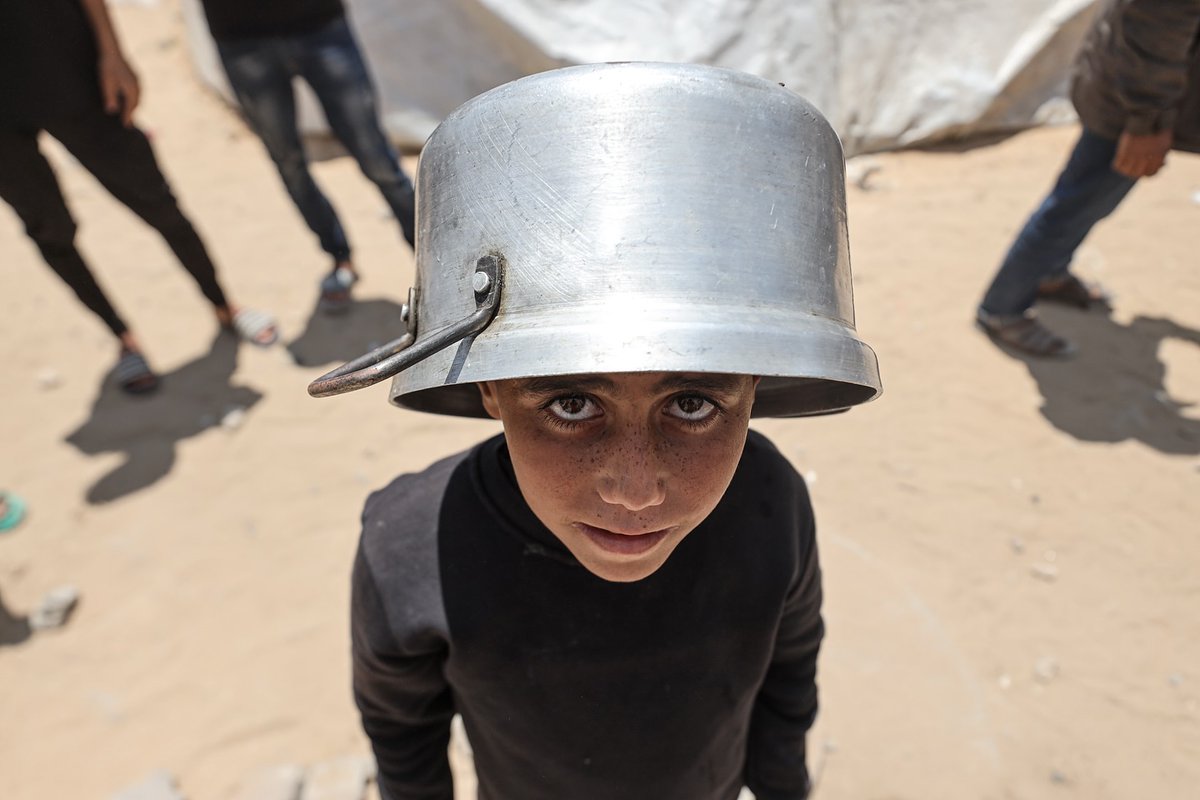 In Gaza, displaced families huddle around boiling pots, not knowing if they’ll eat today.