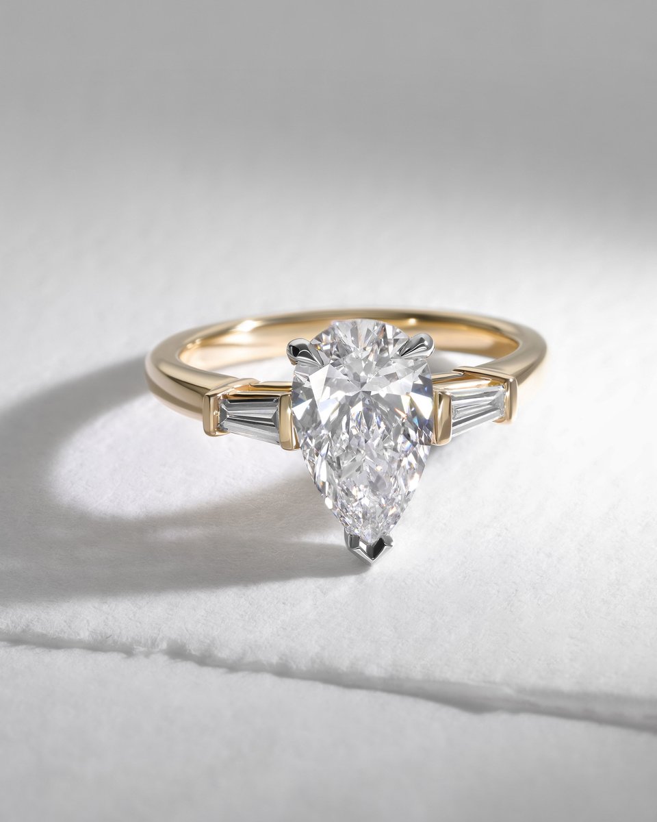 Art Deco meets a droplet of whimsy with this bespoke 18ct yellow gold engagement ring. The centre stone is a 2.00ct pear cut diamond flanked with two tapered baguettes to create a trilogy design 💍✨

 #artdecojewellery #bespokeengagementring #pearcutdiamond
