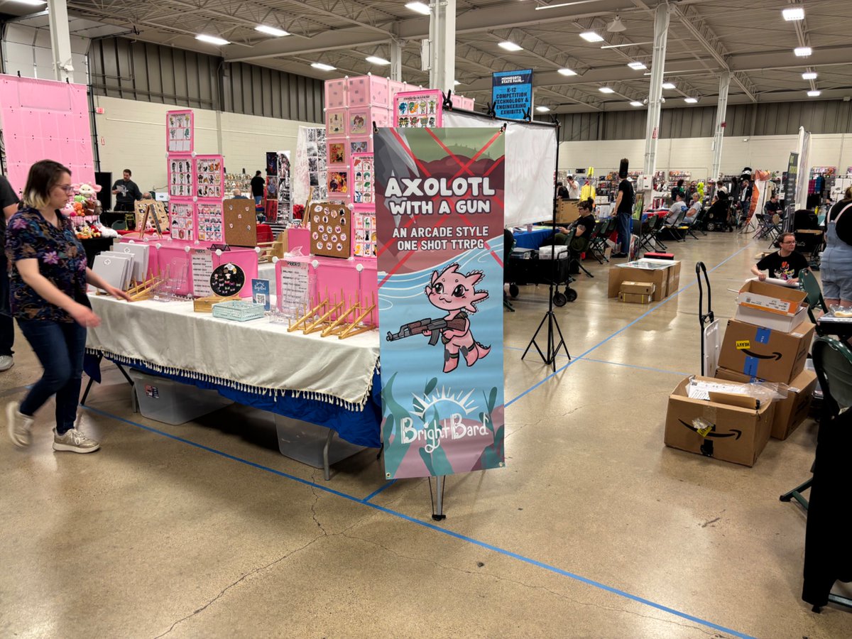 FrederickMelo's tweet photo. The set up the night before… The line around the block this morning… The Minnesota Comic Book Association #MNcBA #SpringCon opens now at the State Fairgrounds, with yours truly in the booth with the best bang for the buck… a $2 local action/drama/killer robots comic! https://t.co/6Uteba7RGl