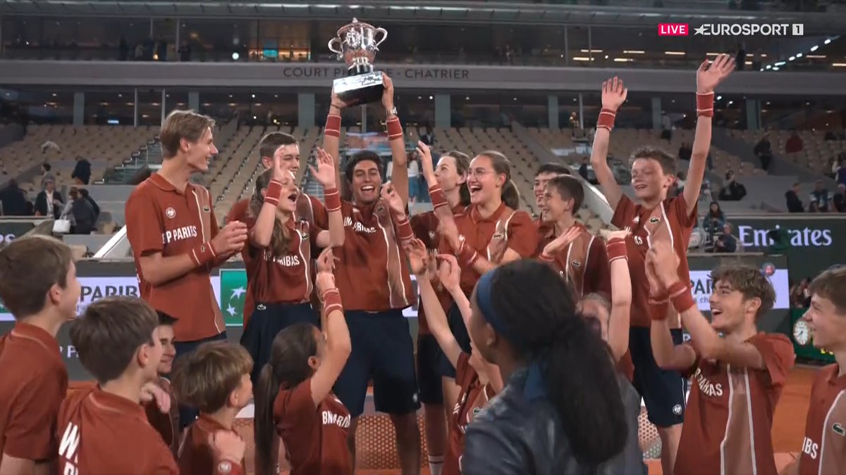 Coco giving the ballkids the trophy to raise.