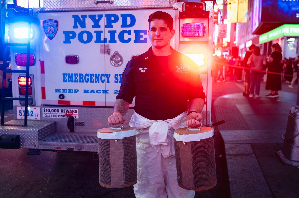 Times Square was buzzing Friday night. Literally. Det. Travis from the Emergency Service Unit safely relocated a swarm of bees to a more suitable home upstate.