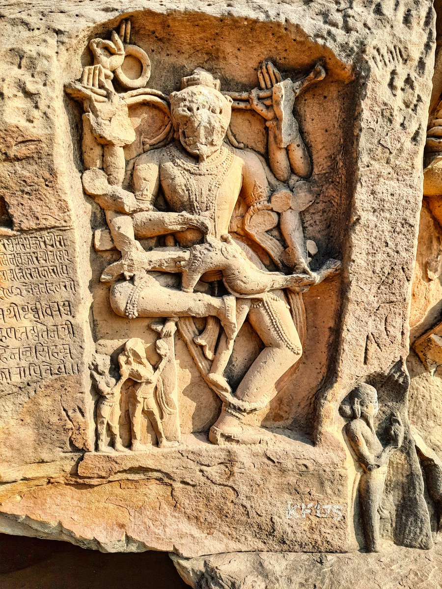Narasimha is shown with twelve hands, holding Hiranyakashipu &amp; two devotees standing to his right, 1135 CE before at Kalinjar Fort.