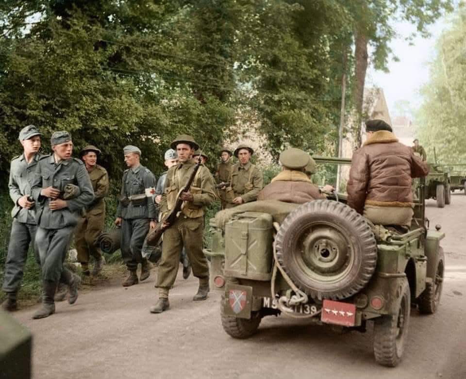 colour_history's tweet image. D-Day + 2
General Sir Bernard Montgomery passes German POWs while being driven in a jeep along a road in Normandy, shortly after arriving on June 8,1944.
(Note, the British, HQ 21st Army Group badge on the left rear of the jeep)
(Photo source - © IWM B 5179)