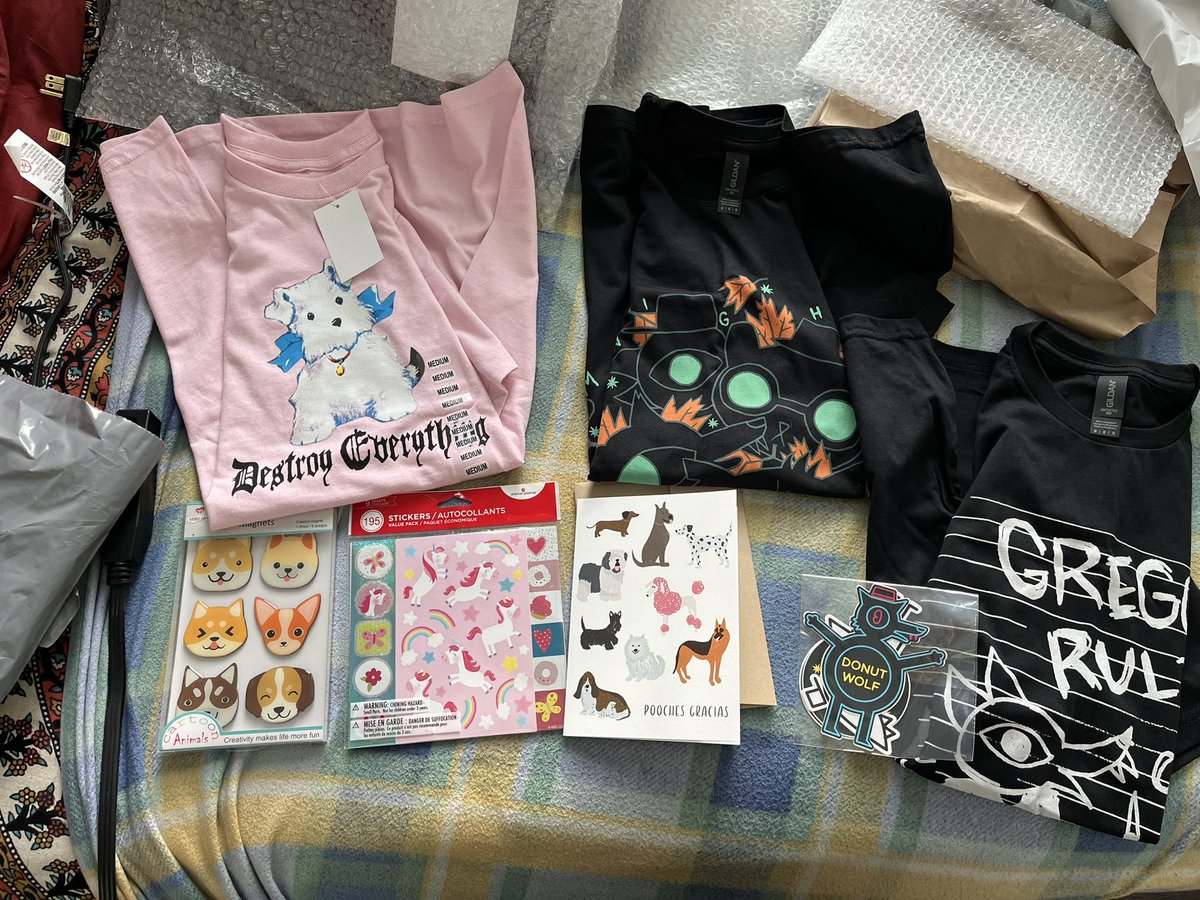 Flum_ber's tweet photo. Here’s the gifts I sent Amoria thanks to Kawa. A couple of Night in the Woods t-shirts and stickers, also some cute pink stickers, dog fridge magnets, a pink t-shirt that felt very Amoria-coded, and a cheesy card. #HappyAmoriaDay2025 https://t.co/iKmMJJRsNs