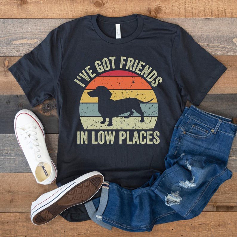 Retro Vintage Look Dachshund T-Shirt, Wiener Dog Tee “I've Got Friends In Low Places”

100% Airlume combed and ringspun cotton (fiber content may vary for different colors)

~Light fabric 
~Retail fit
~Tear away label
~Runs true to size

#dachshundtees 

tidd.ly/43f4Joq