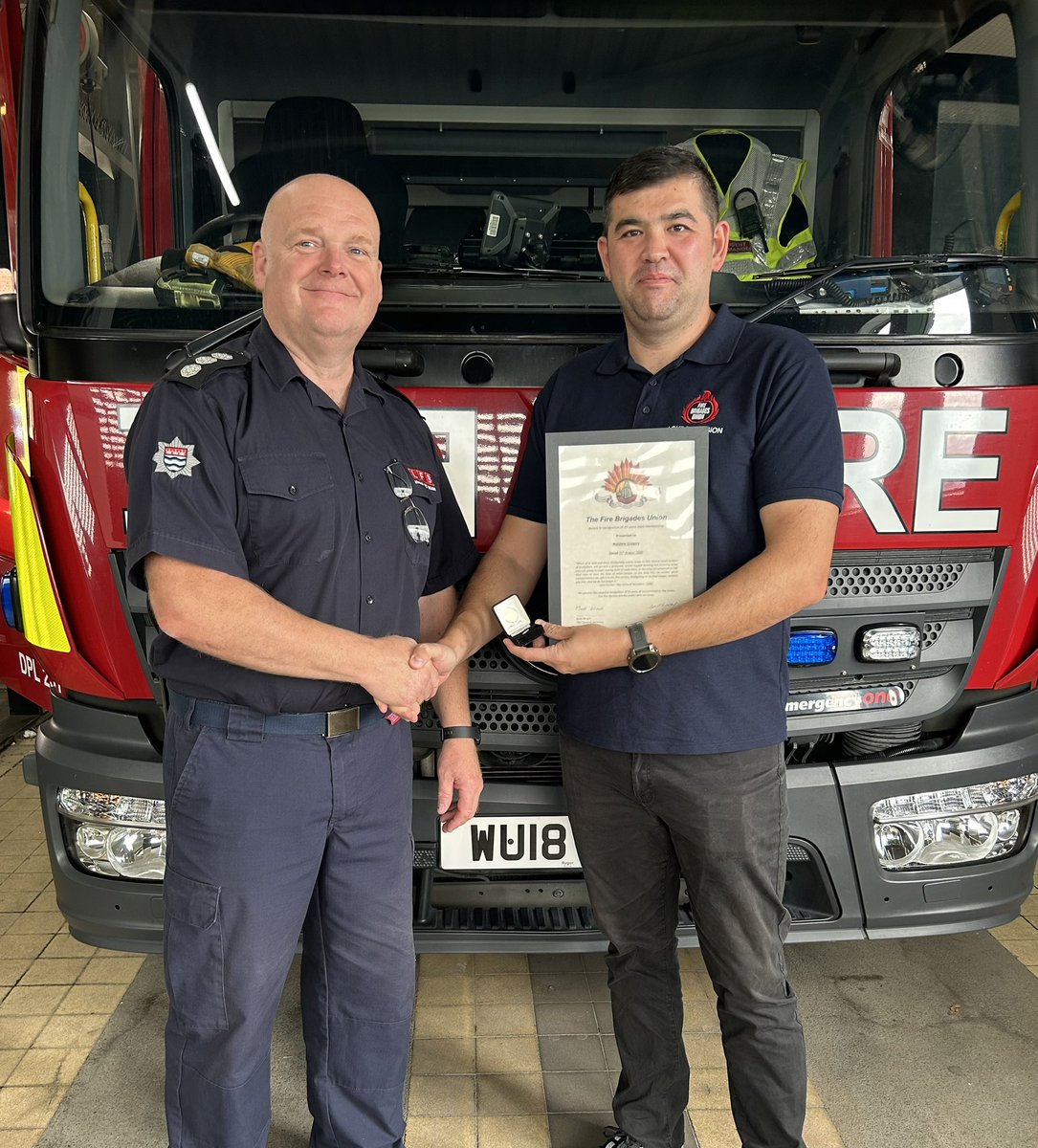 Station Commander Matt Gregory at Heathrow Fire Station receives his 25 year FBU badge from EC member for London David Shek