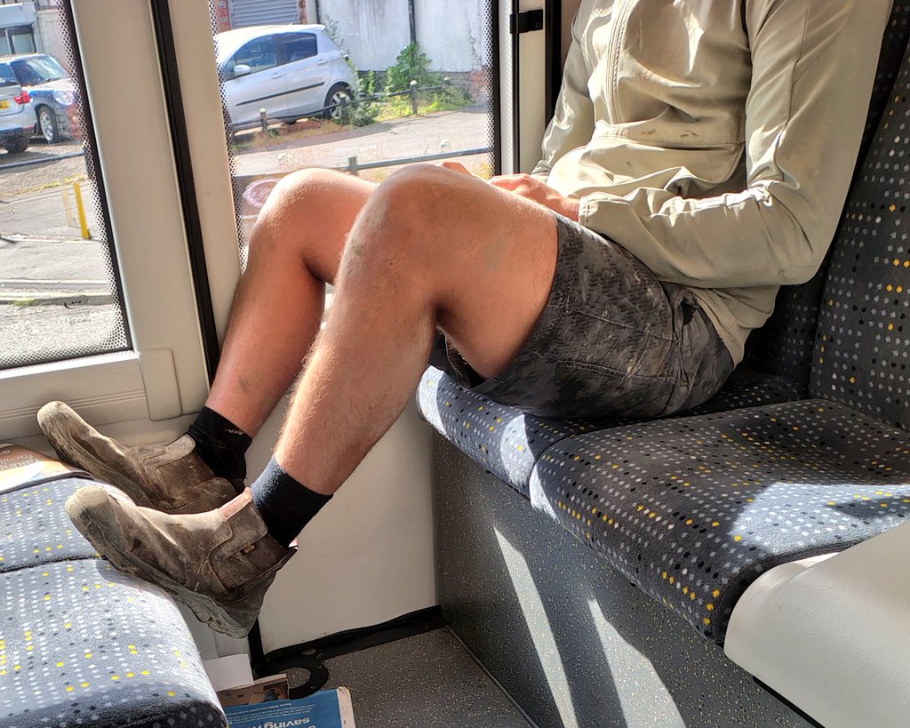 Fit tradie on the bus after work