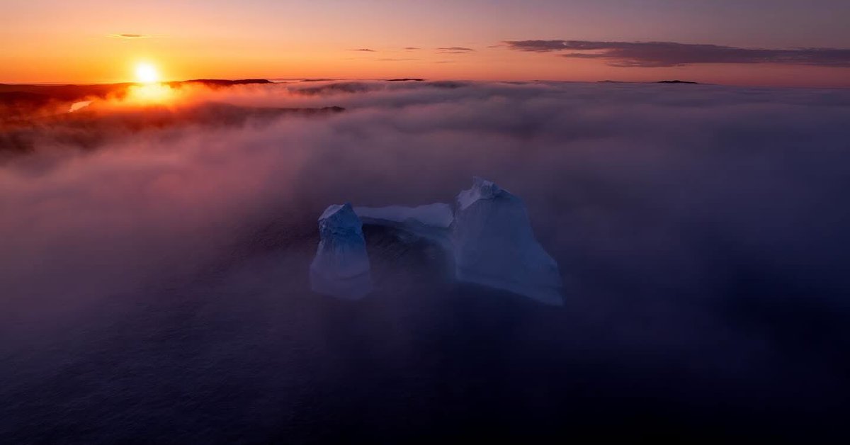 🧊In the stillness of the North, where the sea meets the sky, even icebergs try to slip by unnoticed. 🧊  #VikingTrail #IcebergsNL #sunset #explorenl #foggybutfabulous  #adeventureawaits #travelvibes 📸 Steve Sheppard