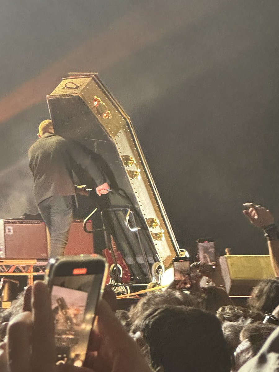 Iggy Pop departing the stage in a coffin.