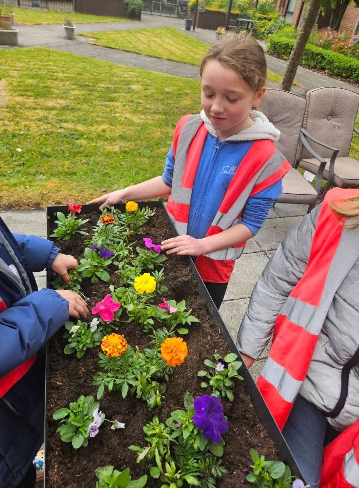 Children and BFY planting flowers in Earlestown.  #communitytogether
