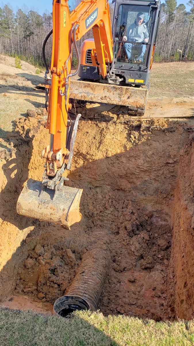 On the left, Mike Jones shaping the 14th green during construction in 1996 and, on the right, he is working on the renovation in 2019. He and his brother, Jeff, were key members of Strantz's small team.