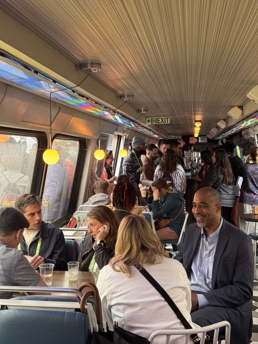 NACTO's tweet image. Day 1 of #DesigningCities: Old friends, new faces, clarion calls to action, a reception inside of a repurposed rail car (!), and, of course, #PlannersPointing.