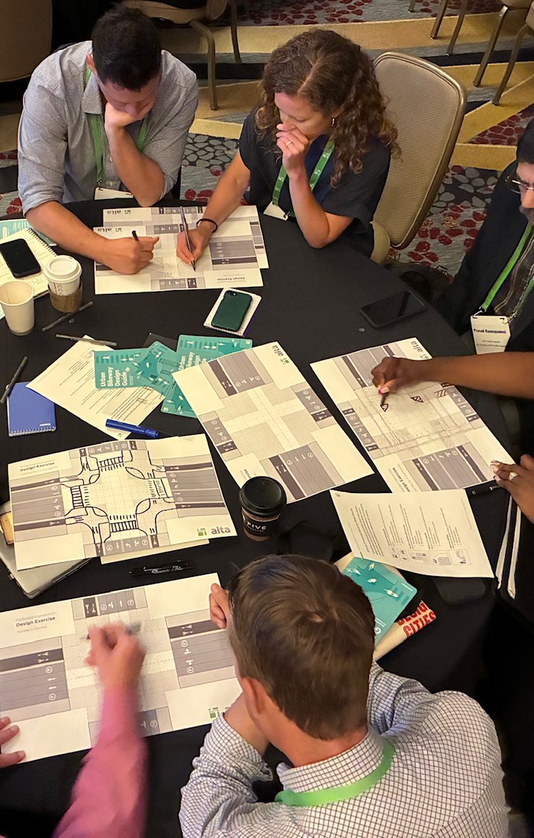 NACTO's tweet image. Day 1 of #DesigningCities: Old friends, new faces, clarion calls to action, a reception inside of a repurposed rail car (!), and, of course, #PlannersPointing.