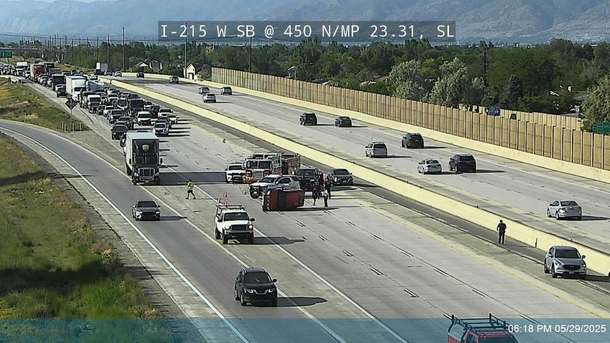 Rollover crash on SB I-215 West Belt after 700 North blocking all lanes. Traffic getting by on the far right shoulder.