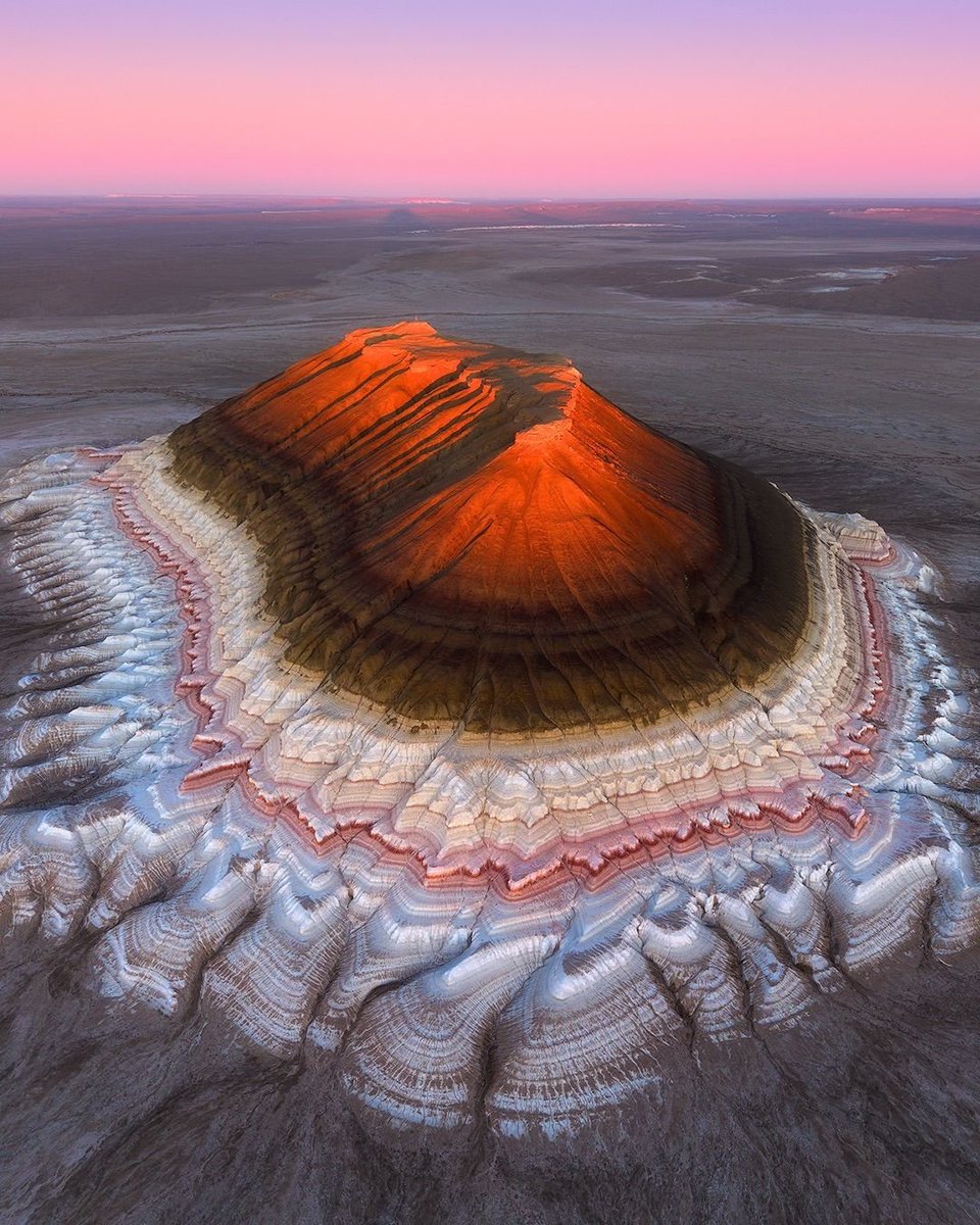 Tucked away in the Mangystau region, Bokty Mountain looks like a massive, perfectly shaped pyramid rising from the desert. 🏜️

Its layered colours and sharp lines make it feel almost otherworldly, some even call it the “Kazakh Sphinx.”

A hidden gem for adventurers and