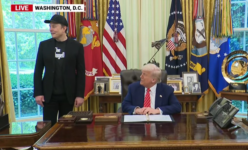 dogeofficialceo's tweet photo. Elon Musk in a ‘DOGE’ hat and ‘The Dogefather’ T-shirt in the Oval Office with the President never gets old 😂 https://t.co/sOw5Veqa70