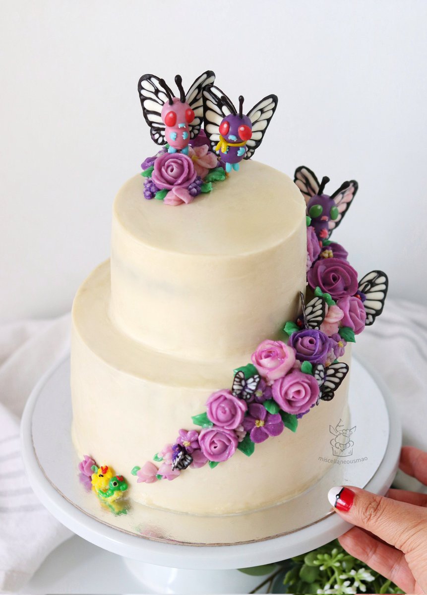 MiscMao's tweet photo. Hello Butterfree cake 🦋💜🦋 Made this to celebrate our 10th wedding anniversary, can you spot all the friends and family hidden throughout? #pokemon #pokemoncake #caterpie #butterfree #バタフリー https://t.co/rab7129j8H