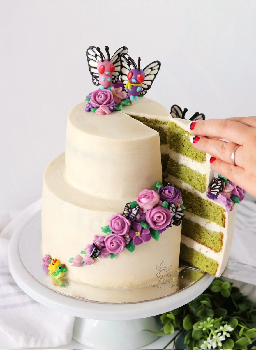 MiscMao's tweet photo. Hello Butterfree cake 🦋💜🦋 Made this to celebrate our 10th wedding anniversary, can you spot all the friends and family hidden throughout? #pokemon #pokemoncake #caterpie #butterfree #バタフリー https://t.co/rab7129j8H